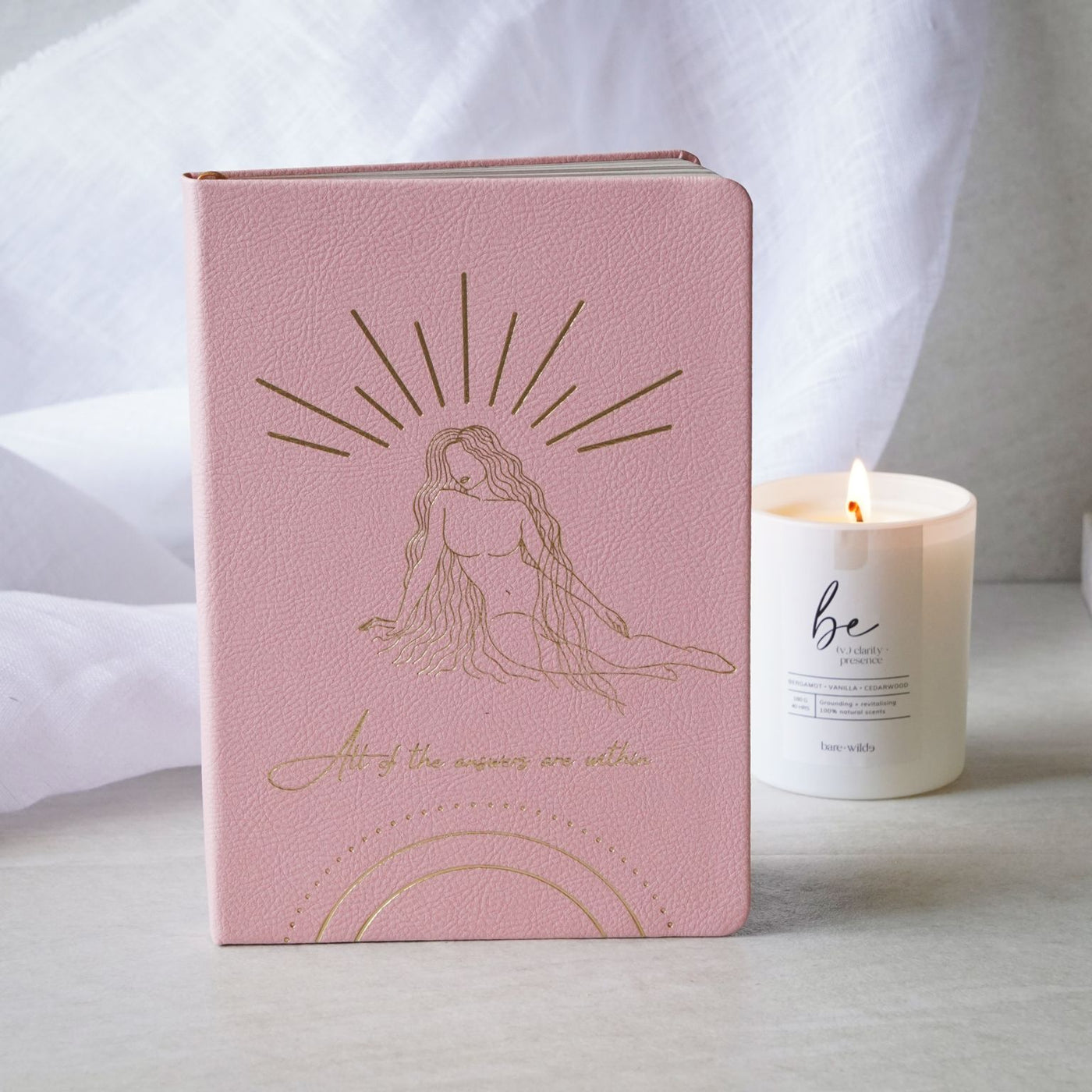 pink journal with candle